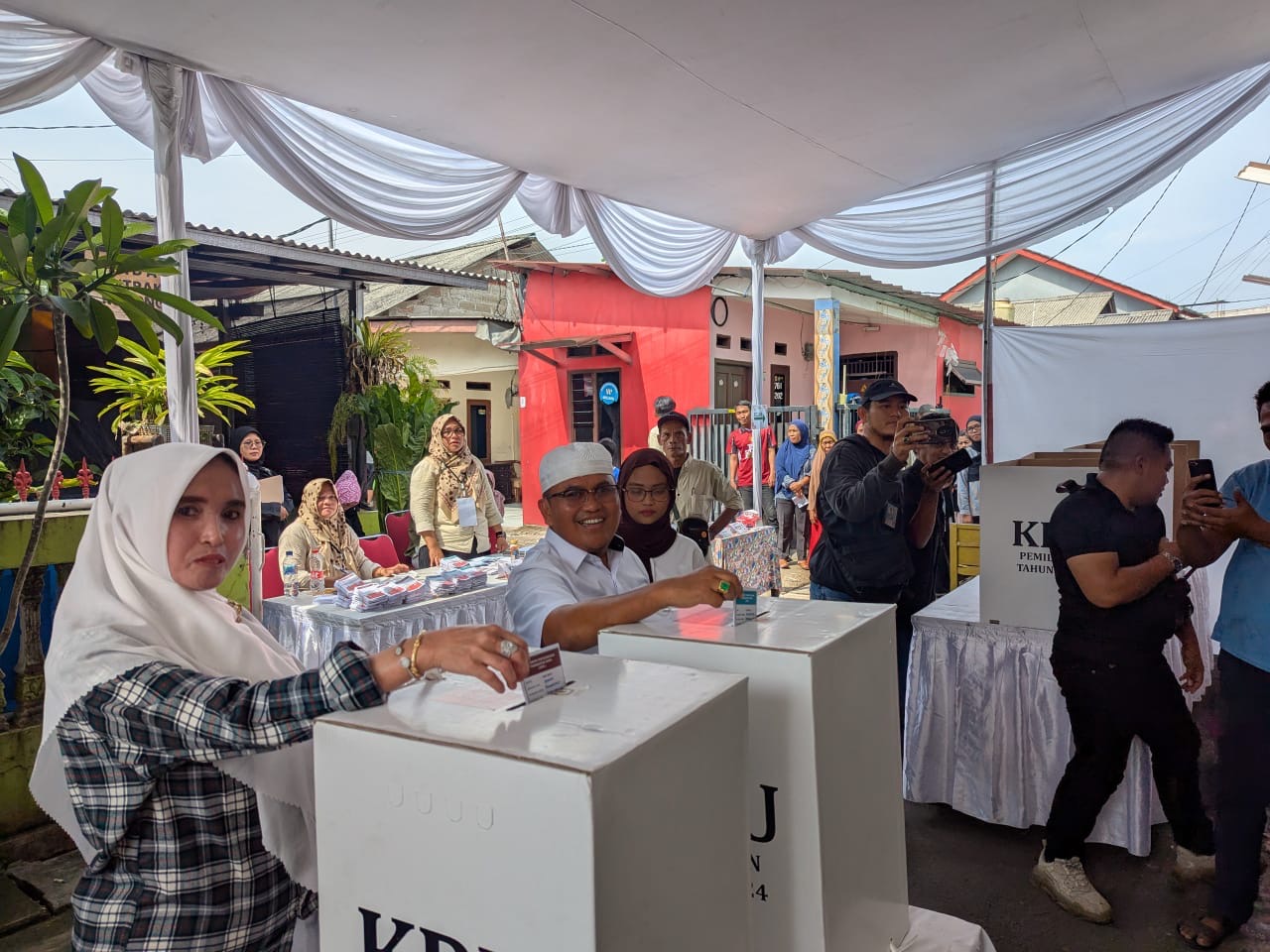 Calon Wakil Wali Kota Bekasi Sholihin menyalurkan hak pilihnya bersama istri. Foto: Ist