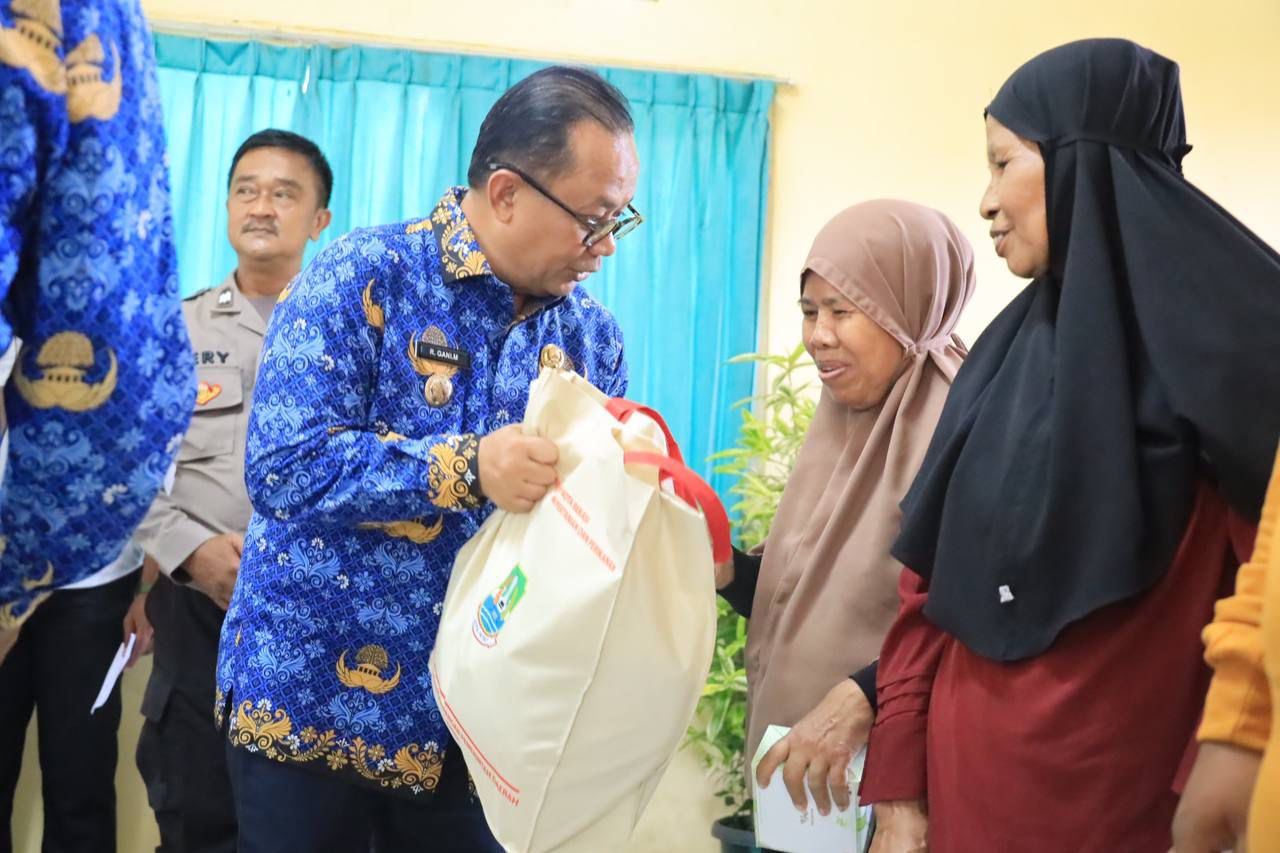Pj Wali Kota Bekasi Raden Gani Muhamad secara simbolis memberikan bantuan pangan kepada warga di rawalumbu. Foto: Ist