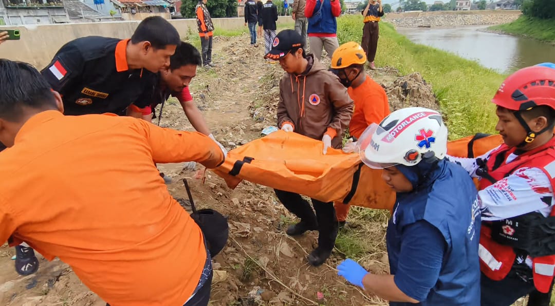 Tim SAR mengevakuasi jenazah anak berinisial ARP (8) yang tenggelam di Kali Bekasi, Minggu (23/2/2025).