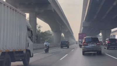 Kota Bekasi - Tangkapan layar video pengemudi sepeda motor nekat mengaspal di Tol Jakarta - Cikampek via GT Bekasi Barat.