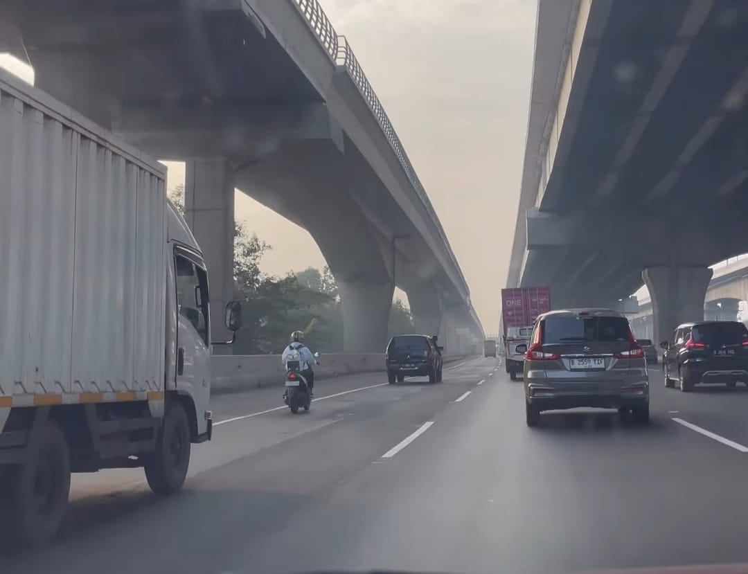 Kota Bekasi - Tangkapan layar video pengemudi sepeda motor nekat mengaspal di Tol Jakarta - Cikampek via GT Bekasi Barat.