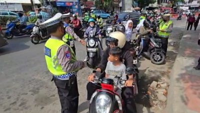Kota Bekasi - Satlantas Polres Metro Bekasi Kota memberikan bunga kepada para pengedara yang tertib berlalu lintas, Jumat (28/11/2025). Foto: Ist/Gobekasi.id.