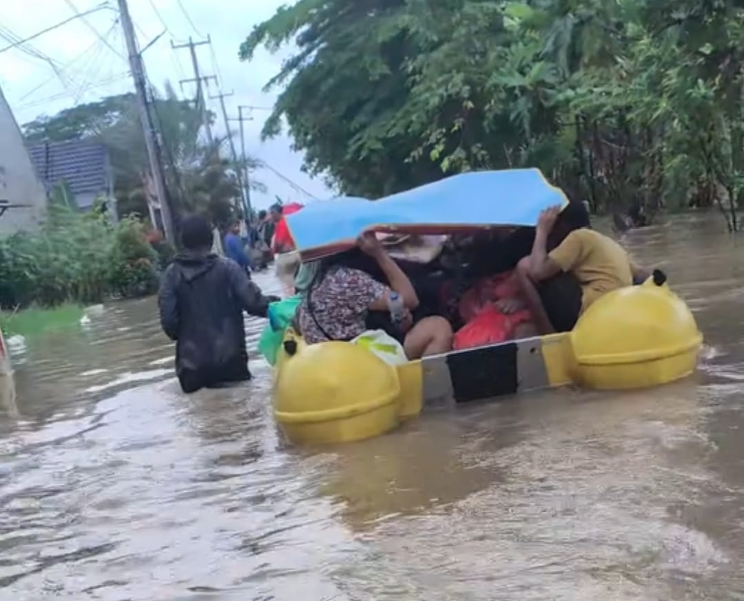 Kabupaten Bekasi - Warga Bekasi Green Village mengevakuasi diri menggunakan perahu karet akibat banjir yang menerjang Jumat (20/2/2026). Foto: Gobekasi.id.
