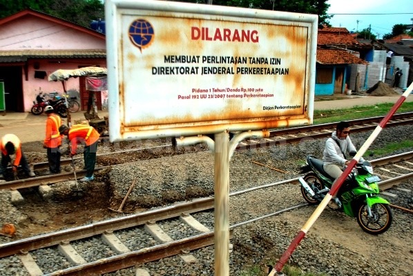 Bekasi - Sejumlah sepeda motor melintas di jalur kereta api yang tidak ada palang pintu perlintasannya di Jl. Yaping Tambun Selatan. Foto: Ist