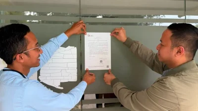 Bekasi - Petugas Otoritas Jasa Keuangan (OJK) memasang pengumuman terkait pencabutan izin usaha PT BPR Citra Bersada Abadi yang beralamat di Kompleks Pertokoan Pasar Pagi Bintara Blok D/20-21, Bintara, Bekasi Barat, Kota Bekasi. Foto: Antara