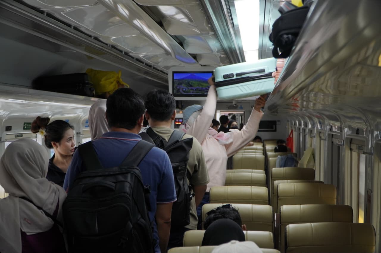 Bekasi - Pengguna kereta api saat menaruh barang bawaanya di rak bagasi. Foto: Ist/Gobekasi.id.